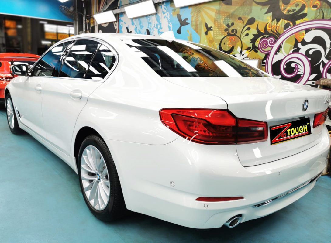 Rear quarter of the BMW 520i, glossy and protected.