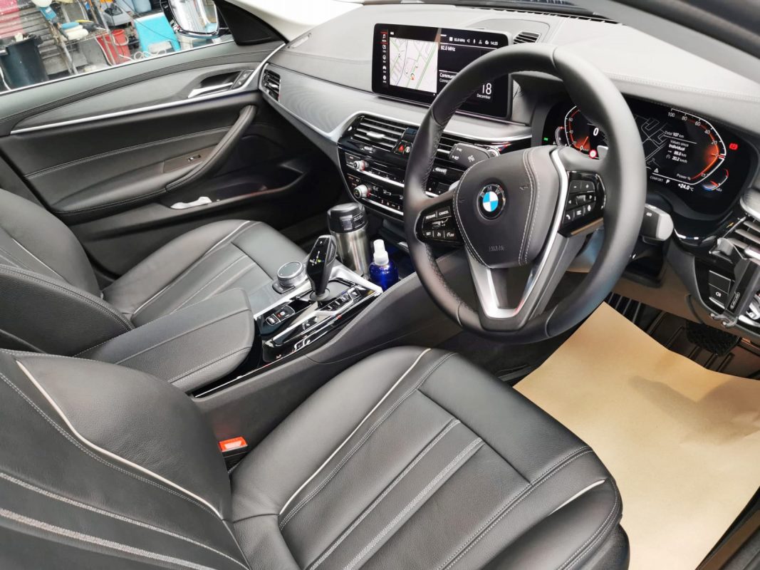 The BMW 520i parked in the workshop, freshly coated.