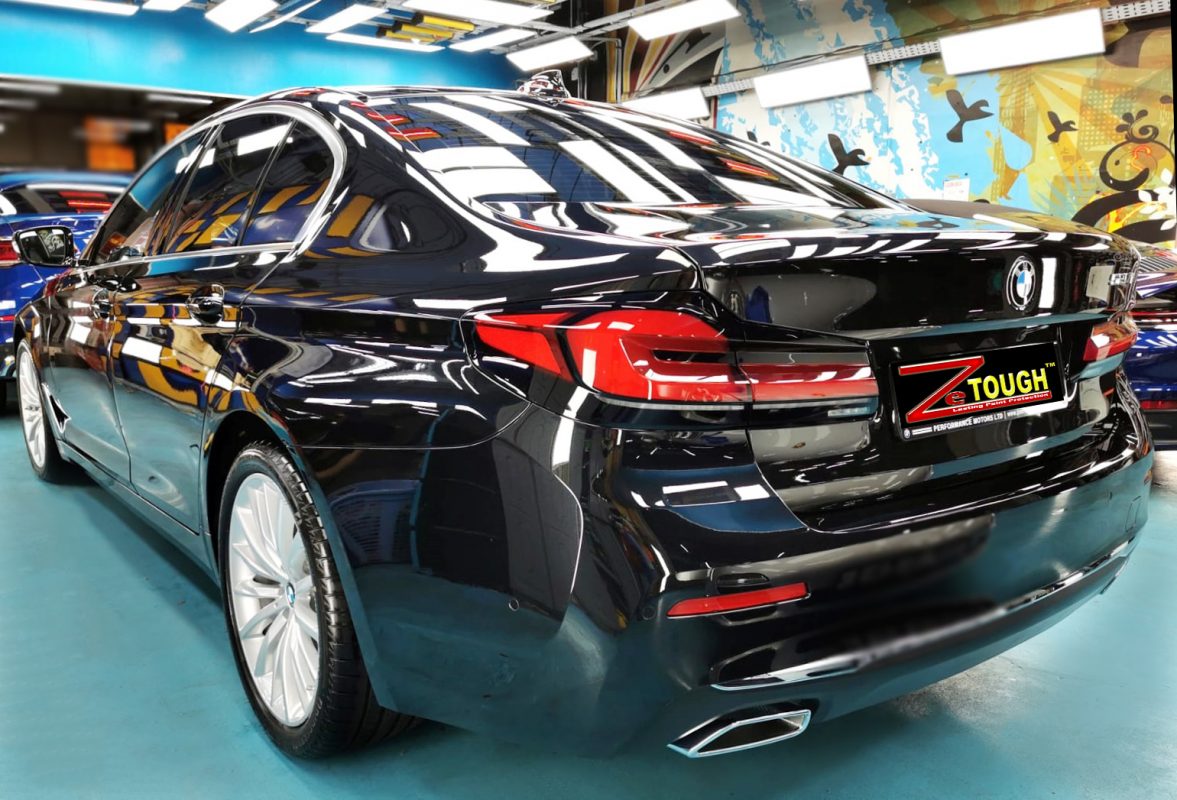 Rear quarter of the BMW 520i, glossy and protected.