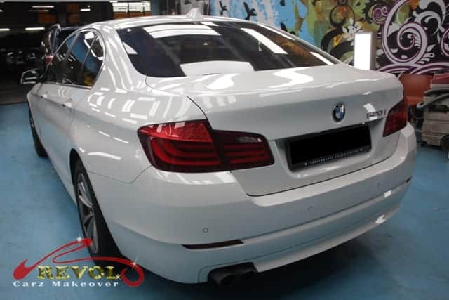 The 520i's coated paintwork holding clean reflections.