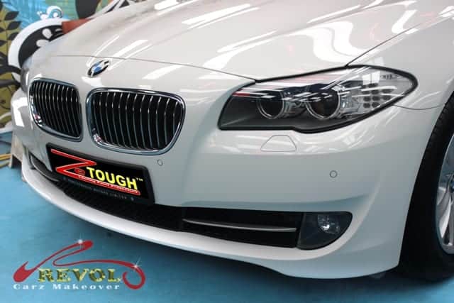 The BMW 520i parked in the workshop, freshly coated.