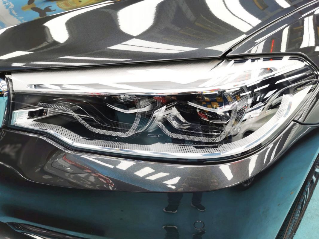 The 520i's coated paintwork holding clean reflections.