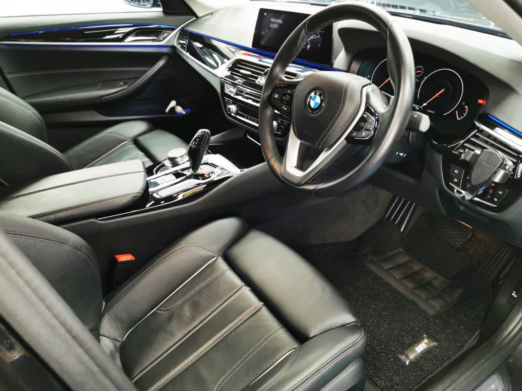 The BMW 520i parked in the workshop, freshly coated.