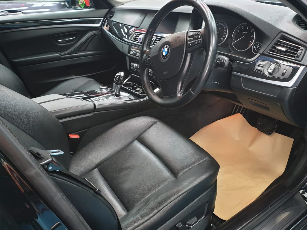The BMW 523i parked in the workshop, freshly coated.