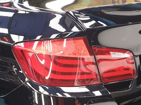 Rear quarter of the BMW 523i, glossy and protected.