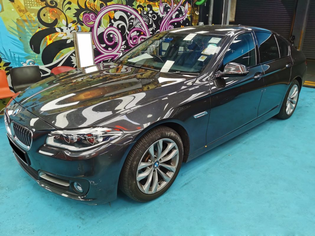 BMW 528i at Revol Carz on arrival day, paint chips and scratches across the bodywork.