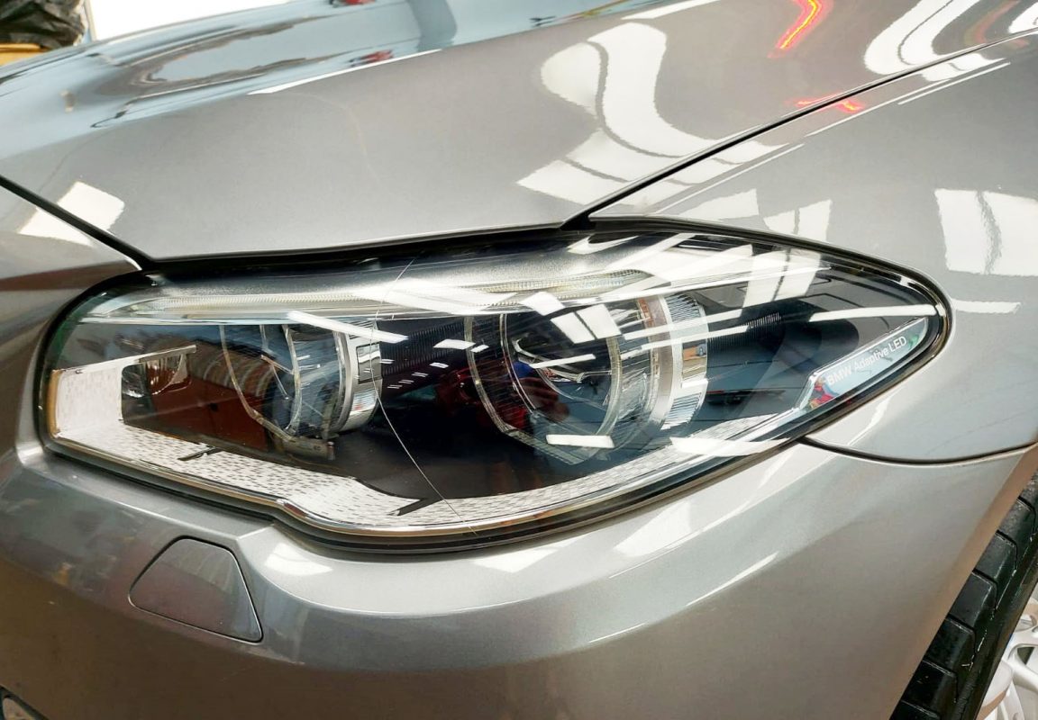 The 528i's coated paintwork holding clean reflections.