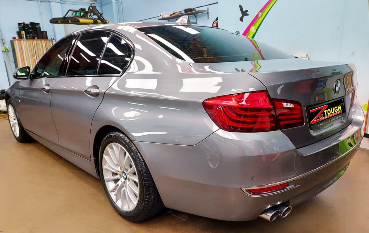 Rear quarter of the BMW 528i, glossy and protected.