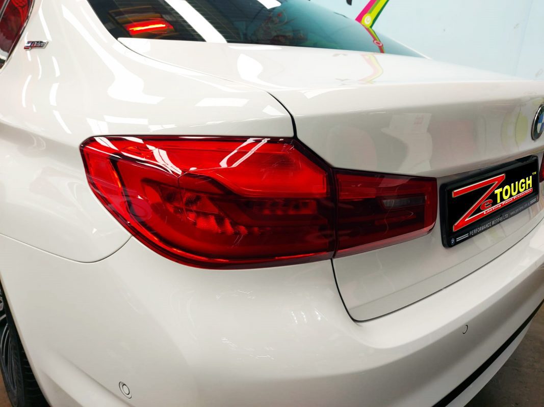 The coated bonnet of the BMW 530e under workshop lighting.