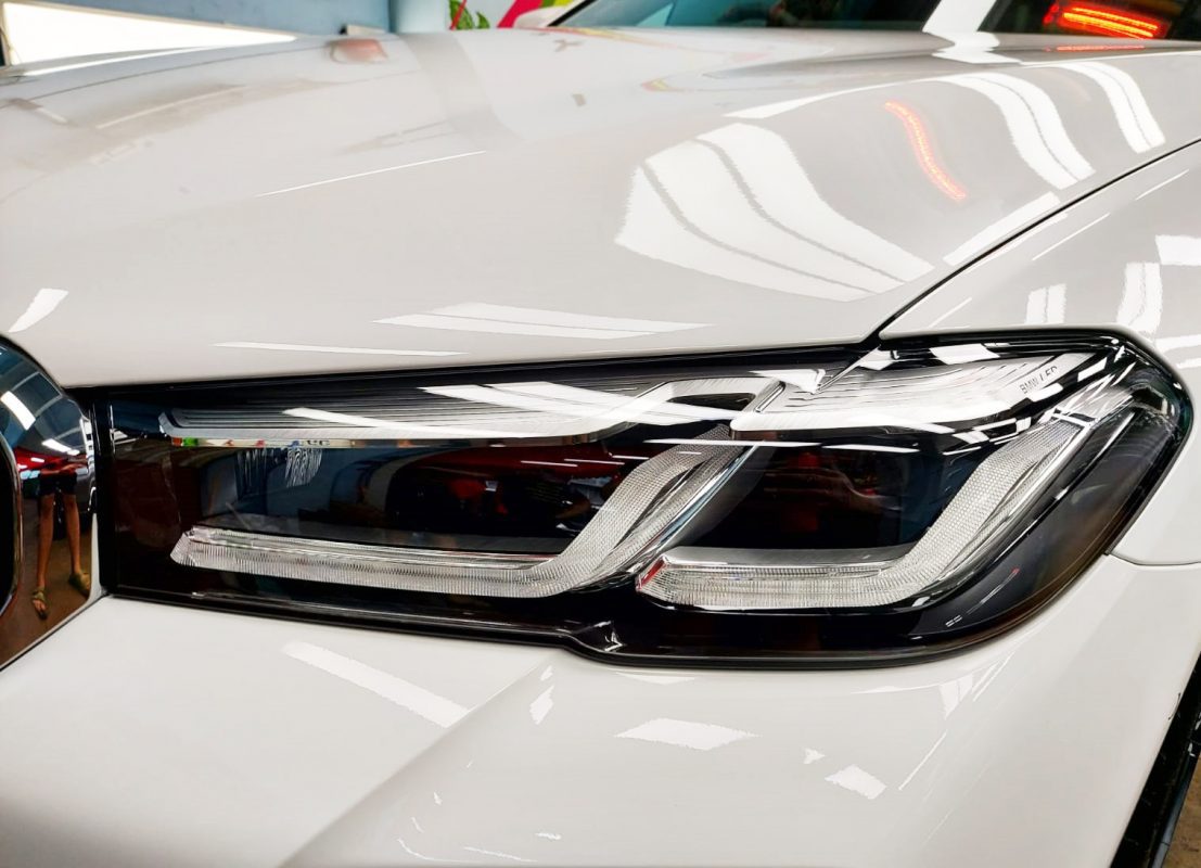 The 530i's coated paintwork showing clean reflections.