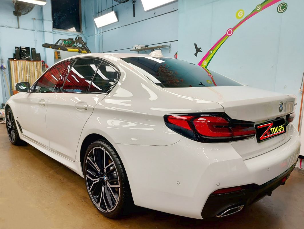 Rear quarter of the BMW 530i, glossy and protected.