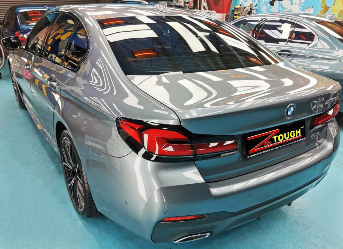 Rear quarter of the BMW 530i, glossy and protected.