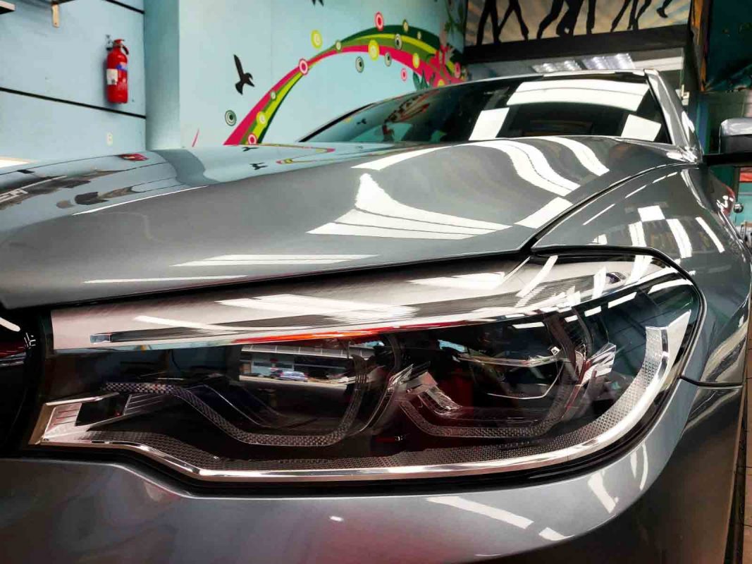 The 540i's coated paintwork showing clean reflections.