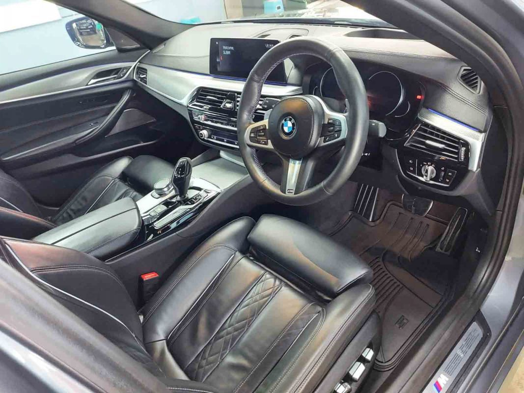 The BMW 540i parked in the workshop, freshly coated.