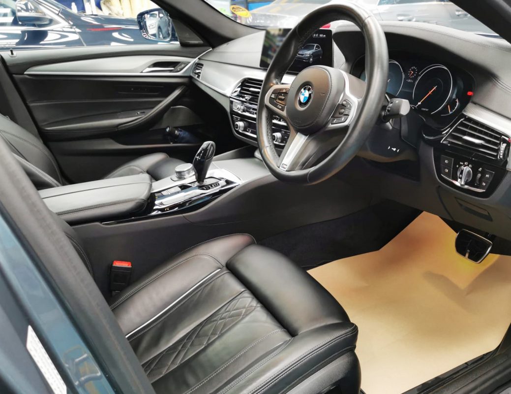 The BMW 540i parked in the workshop, freshly coated.