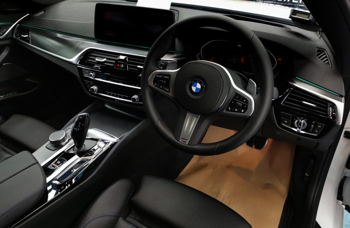 The BMW 5 Series parked in the workshop, freshly coated.