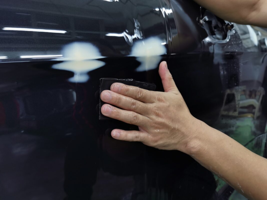 Wet-sanding the 6 Series' panels to smooth the existing paintwork.