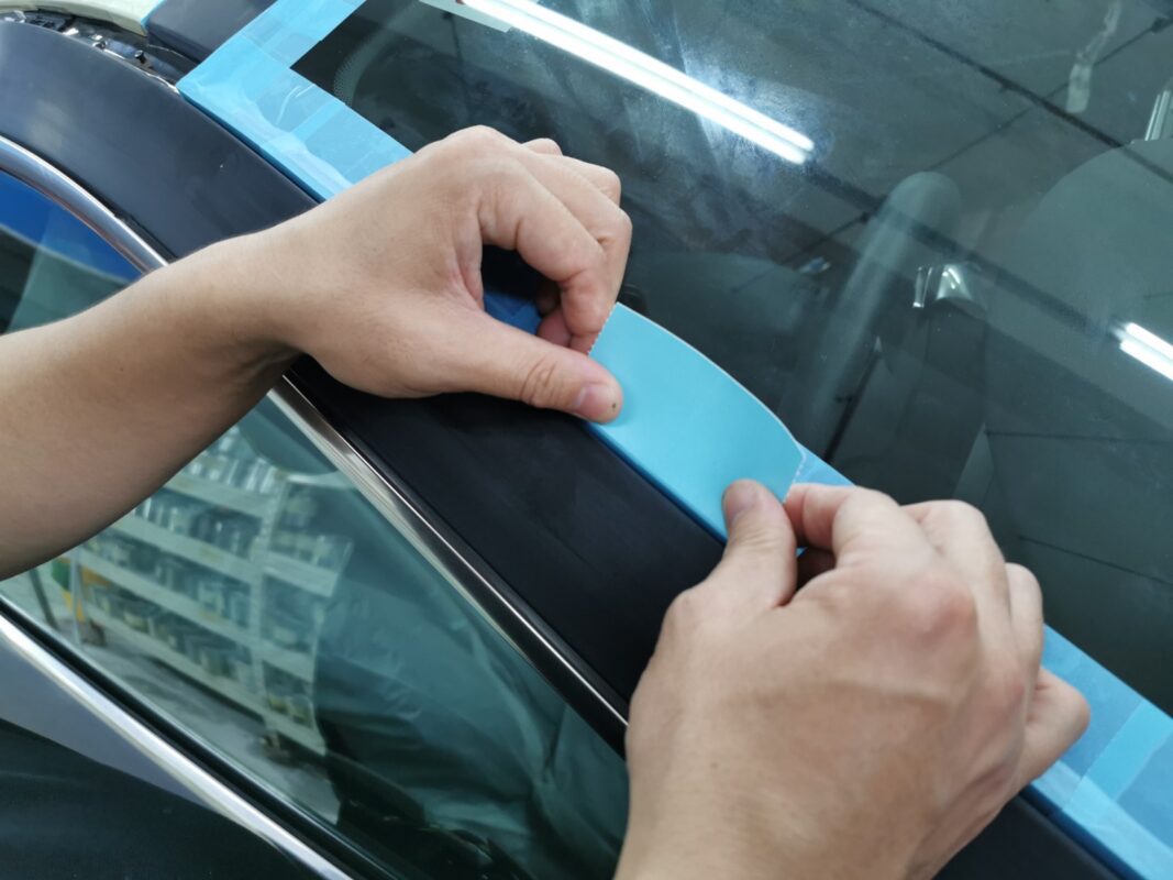 Non-painted surfaces being masked off on the 6 Series before spraying.
