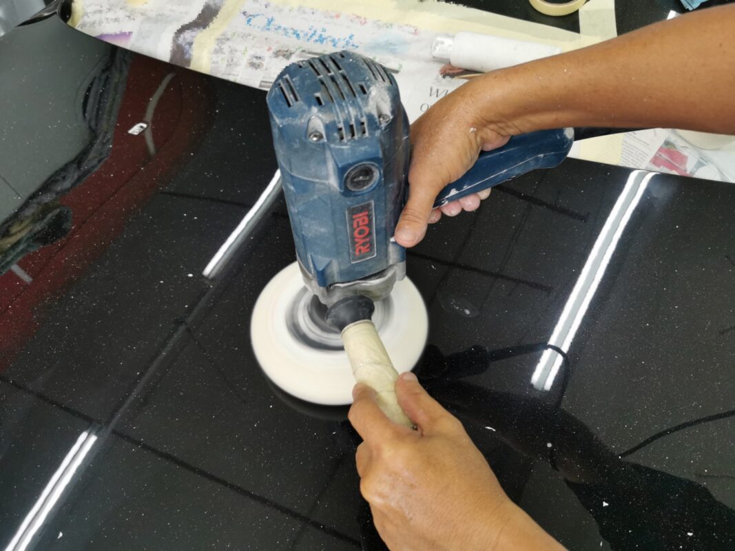 The 6 Series being wet-sanded again after spraying for an even surface.