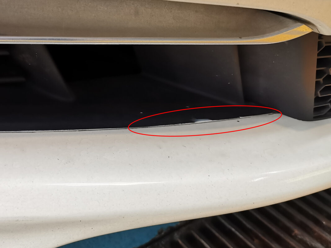 BMW 6 Series rear three-quarter on arrival, overspray and uneven finish visible.