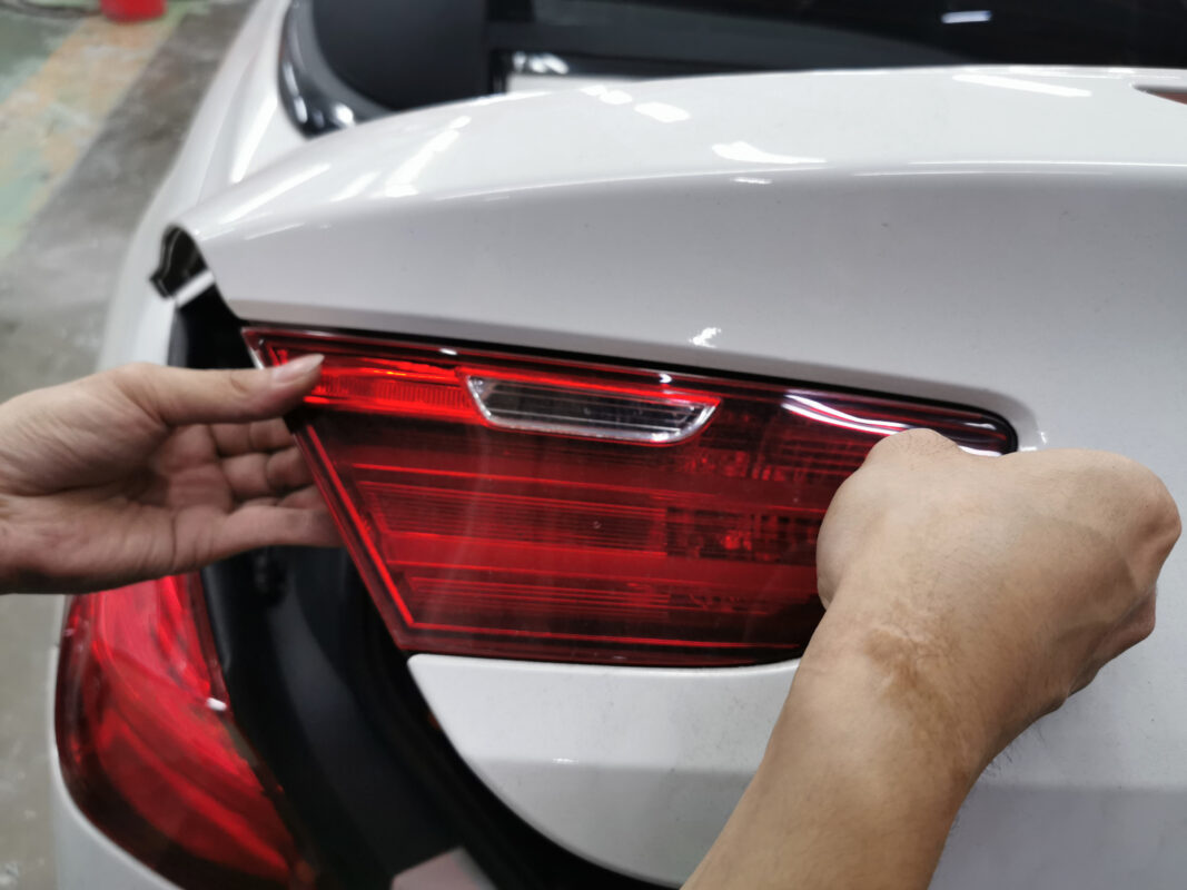 Trim and components stripped from the BMW 6 Series, panels exposed.