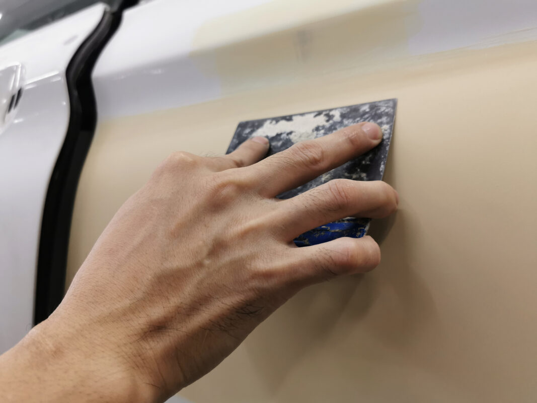 Surface repair work on the BMW 6 Series, smoothing out scratches and blemishes.