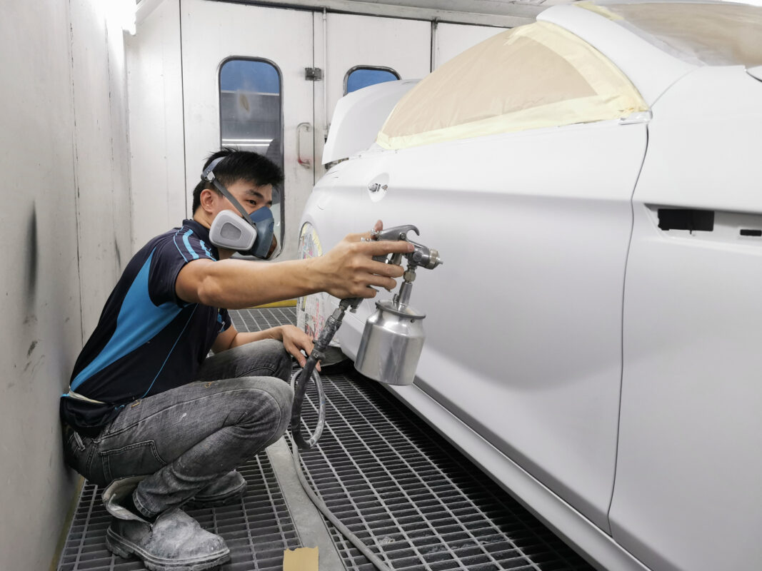 The BMW 6 Series in the spray booth receiving a fresh coat of paint.