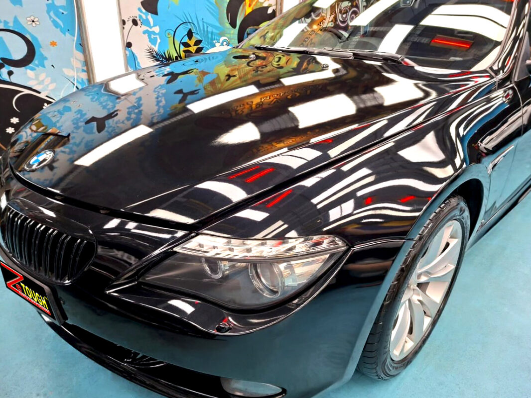 The BMW 6 Series's coated paintwork under workshop lighting.