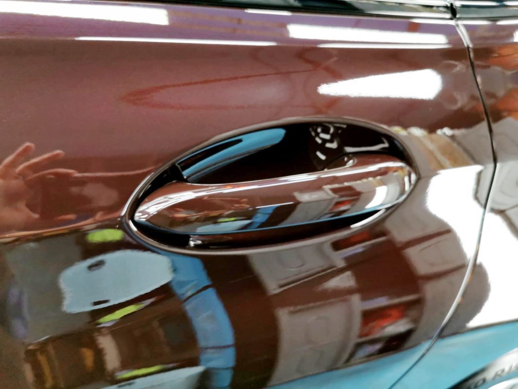 The coated bonnet of the BMW 630i under workshop lighting.