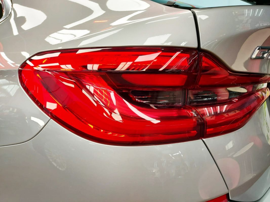The coated bonnet of the BMW 630i GT under workshop lighting.