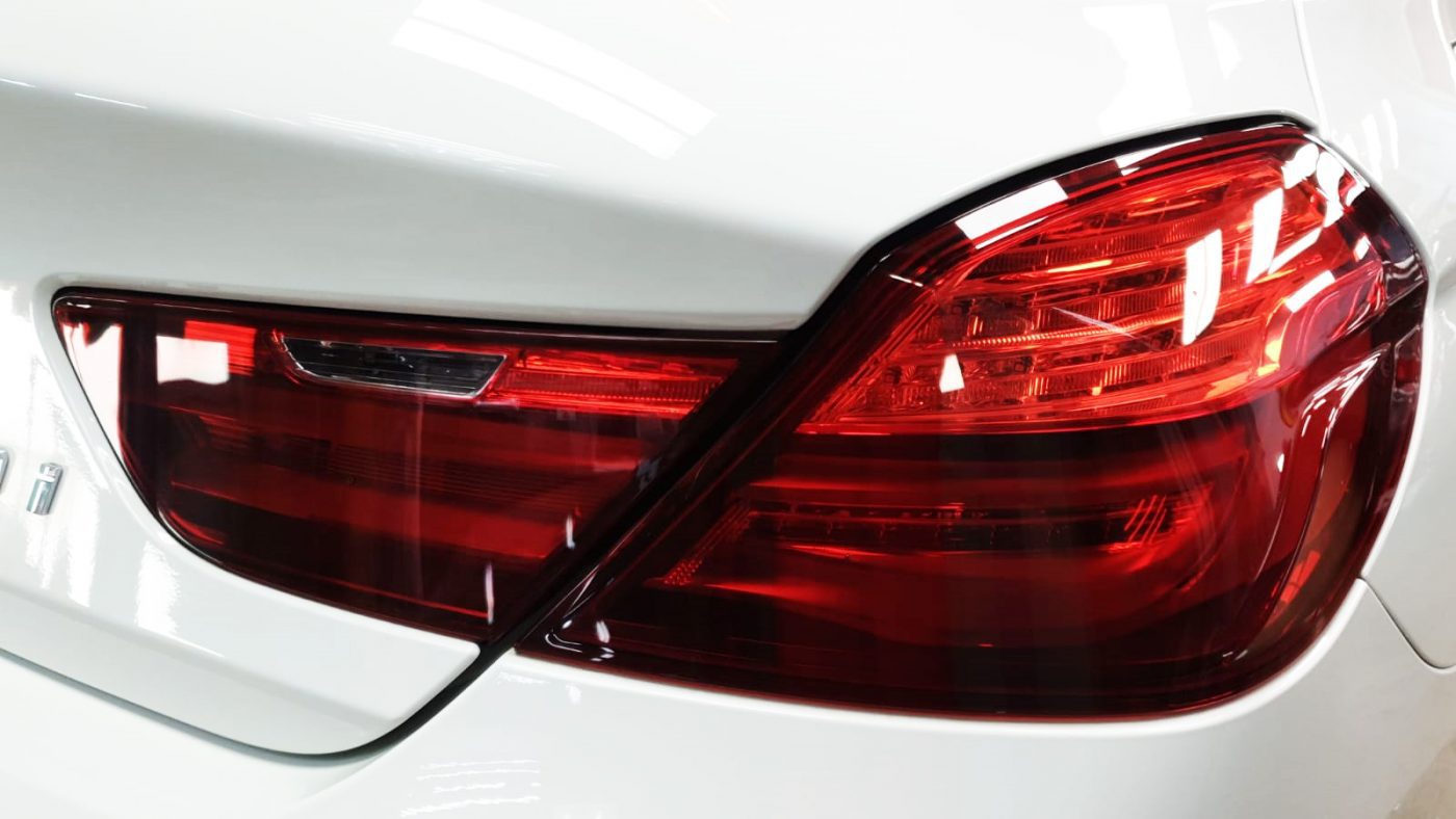 The coated bonnet of the BMW 640i under workshop lighting.