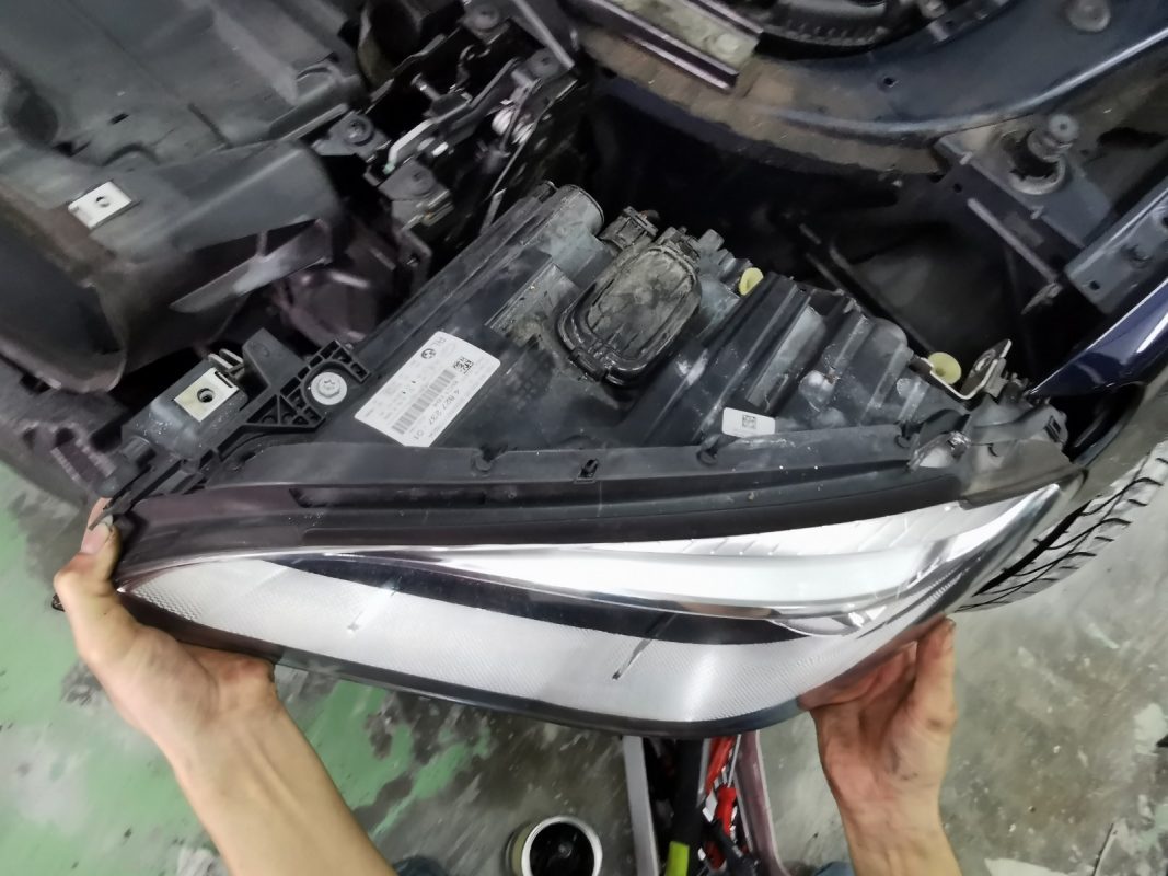 Necessary parts being dismantled from the 7 Series before spraying.