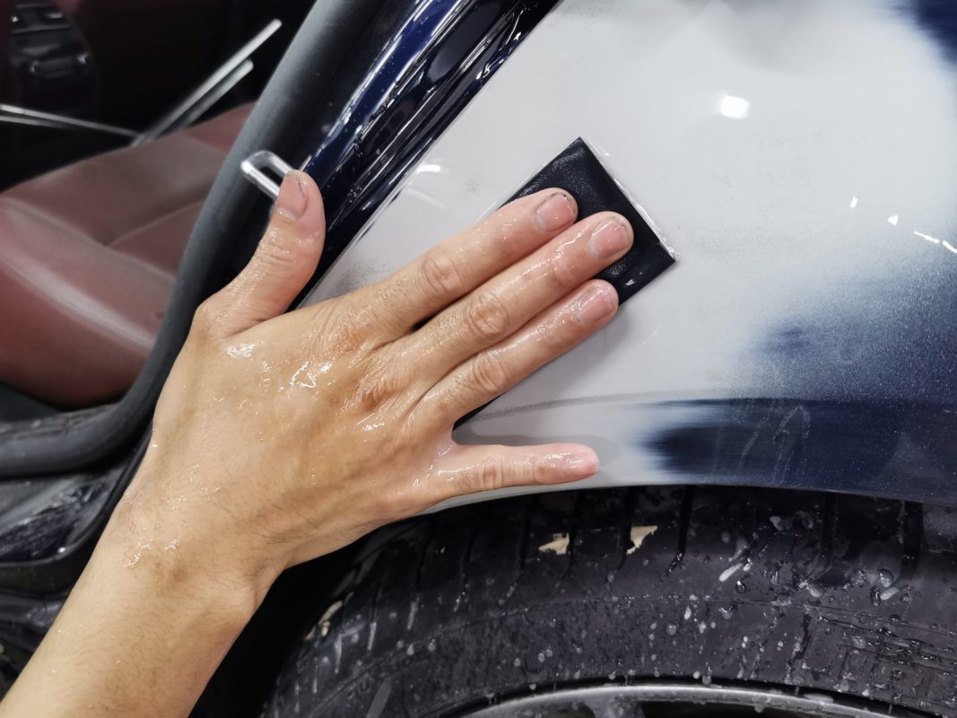 Continuing to wet-sand the body in preparation for spraying.