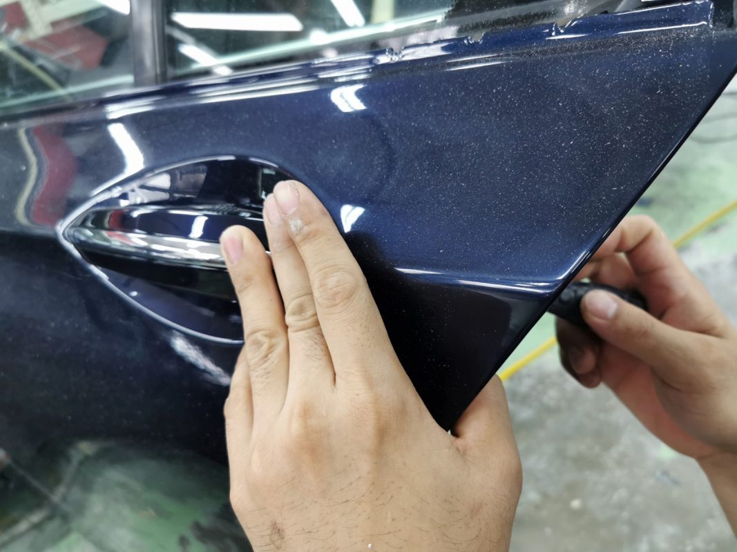 Buffing the new paint on the 7 Series to bring up the shine.