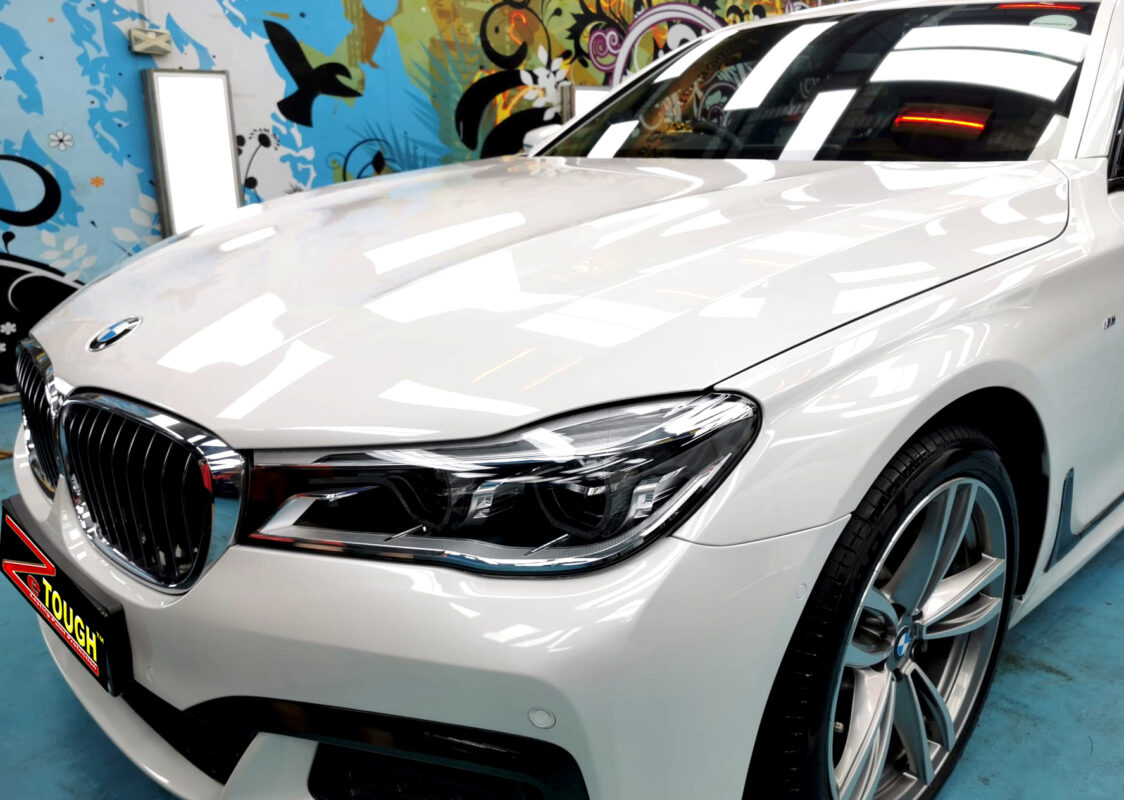 The BMW 7 Series's coated paintwork under workshop lighting.
