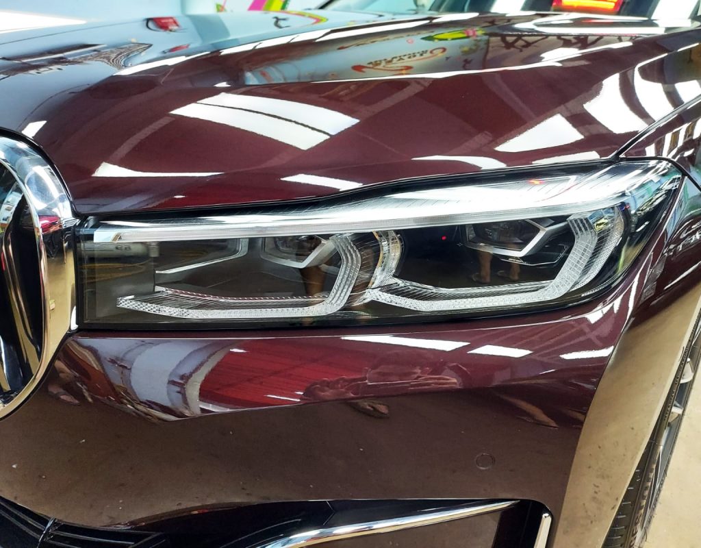 The 730i's coated paintwork showing clean reflections.