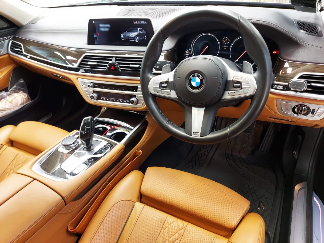 Rear quarter of the BMW 740Li, glossy and protected.