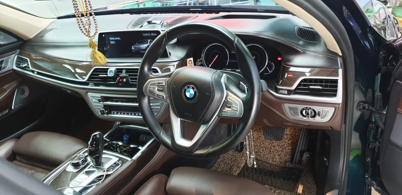 Rear quarter of the BMW 750Li, glossy and protected.