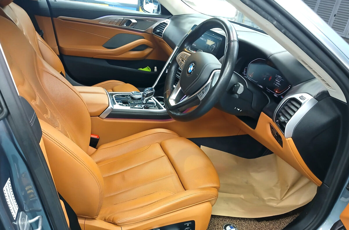 The BMW 8 Series parked in the workshop, freshly coated.