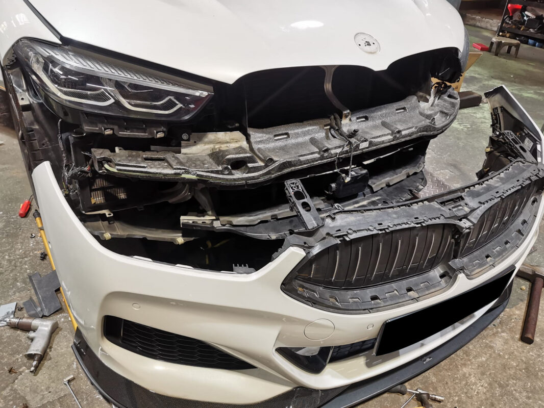 The BMW 840i Cabriolet in the workshop on Day 2, panels being removed for strip-down.