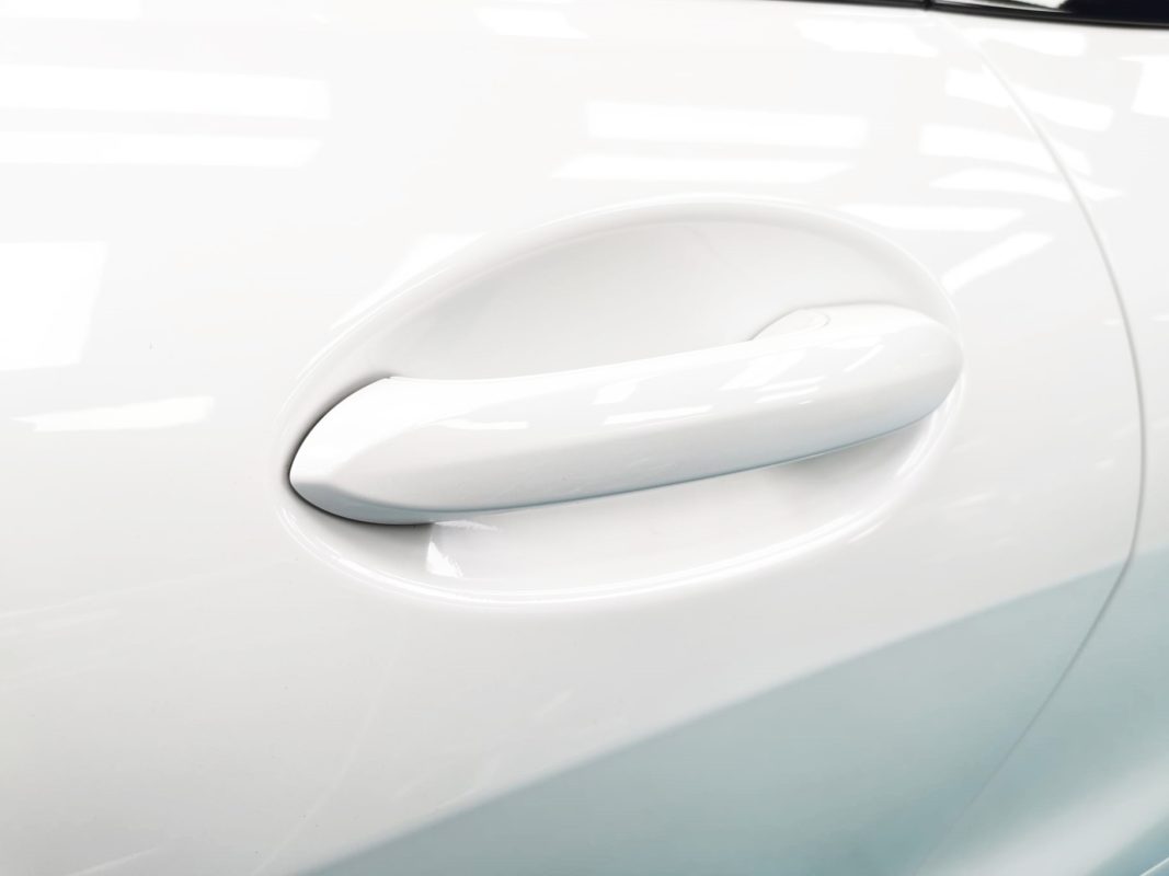 The 840i Cabriolet's coated bonnet under workshop lighting.