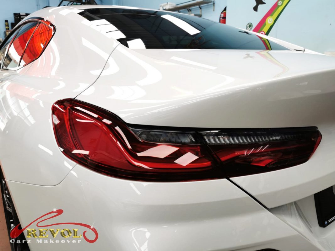 The coated bonnet of the BMW 840i Gran Coupe under workshop lighting.