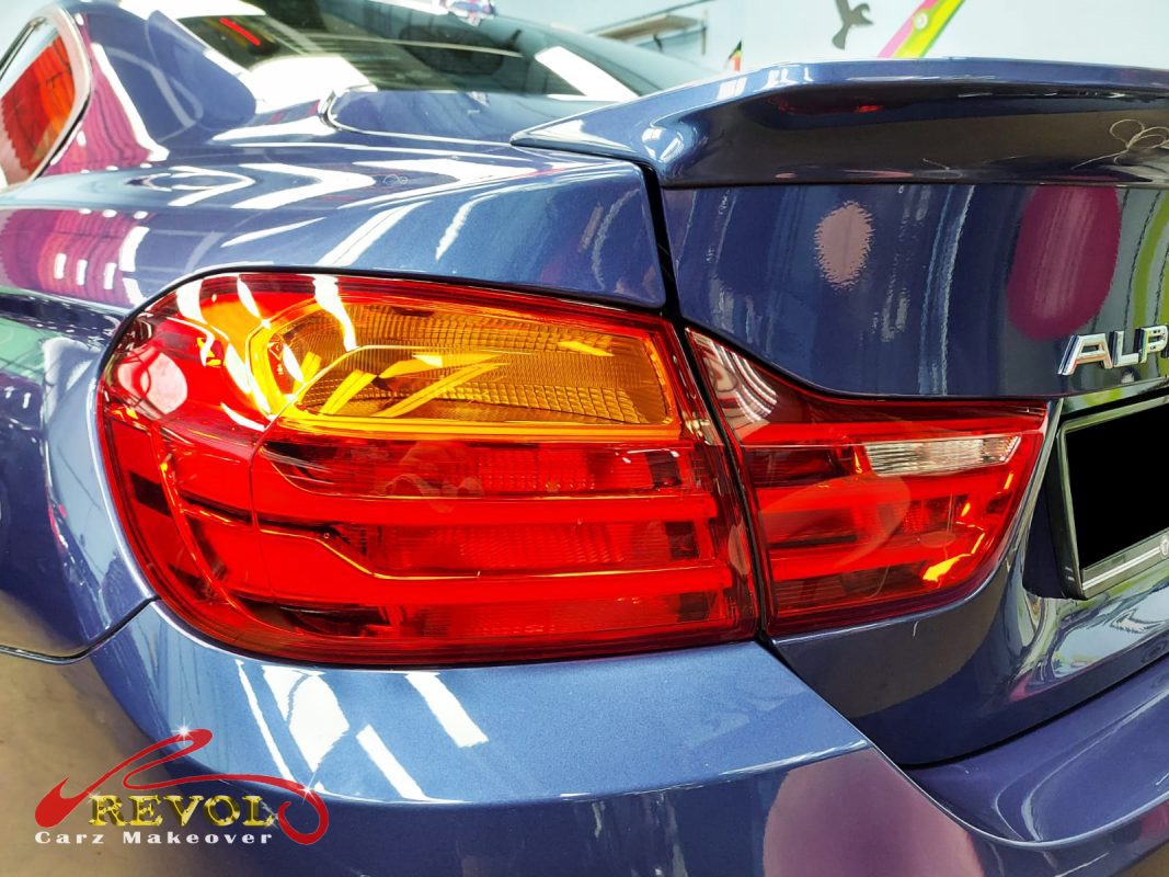 The coated bonnet of the Alpina B4 under workshop lighting.