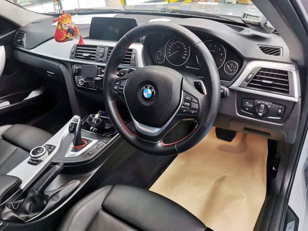 Rear quarter of the BMW 330i, glossy and protected.