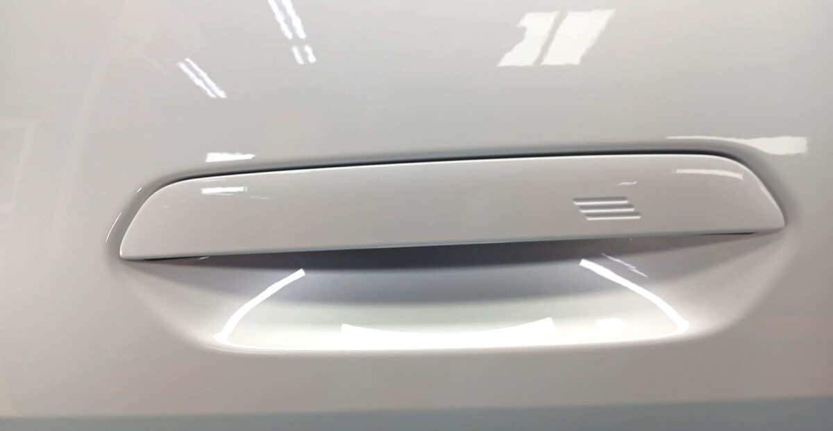 Rear quarter of the BMW i4, glossy and protected.