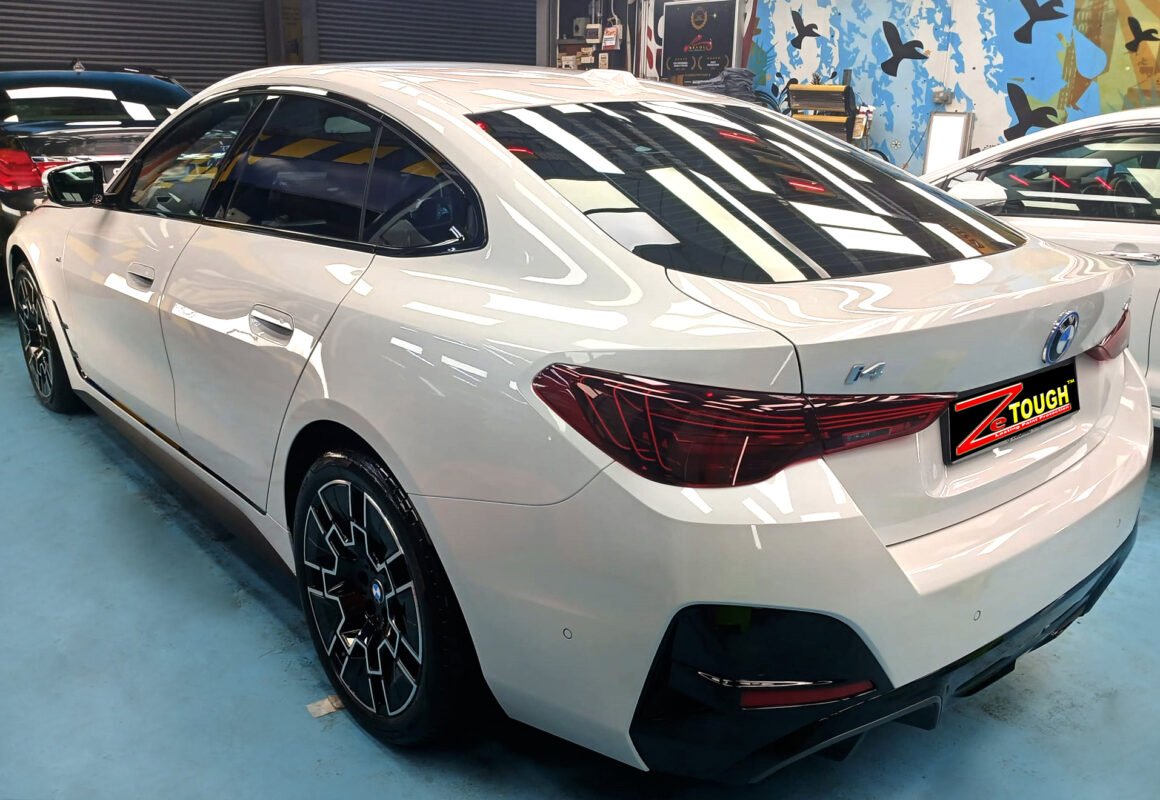 The coated bonnet of the BMW i4 under workshop lighting.