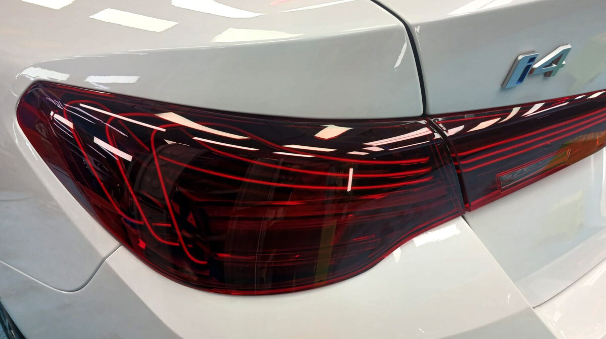 The BMW i4 parked in the workshop, freshly coated.