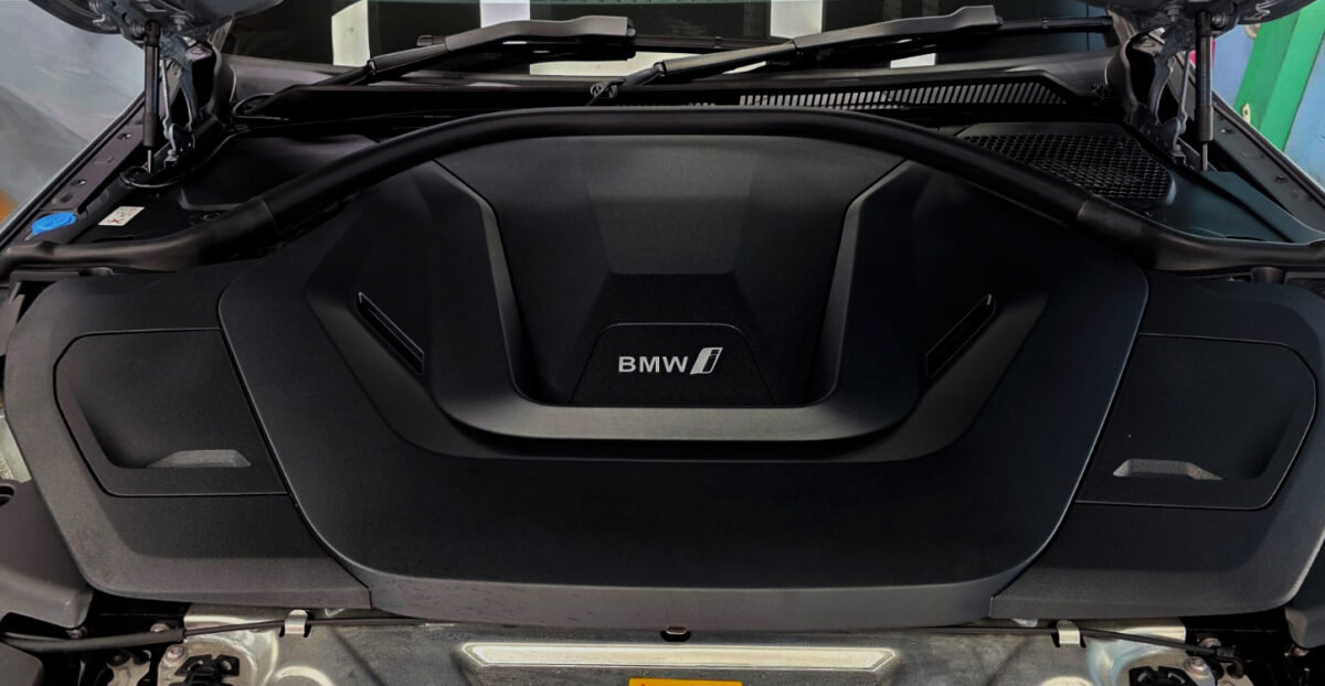 Reflections across the coated panels of the BMW i4.