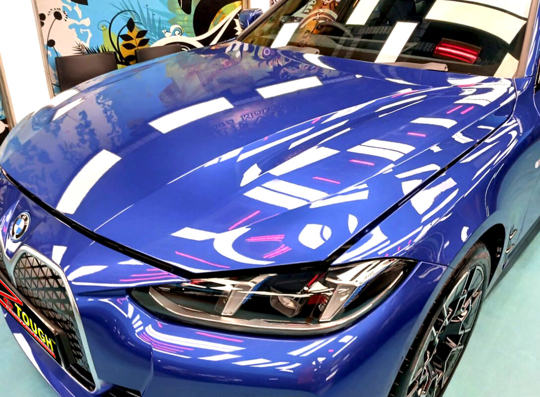 The BMW i4 from a side angle after the titanium coating.