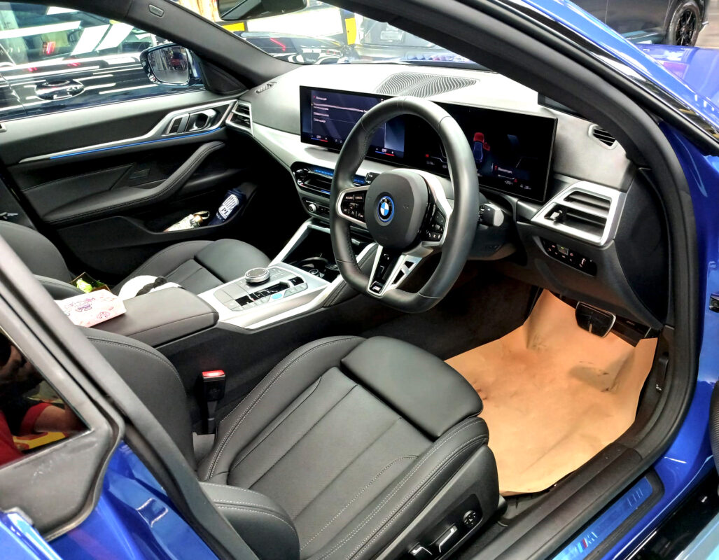 The BMW i4 parked in the workshop, freshly coated.